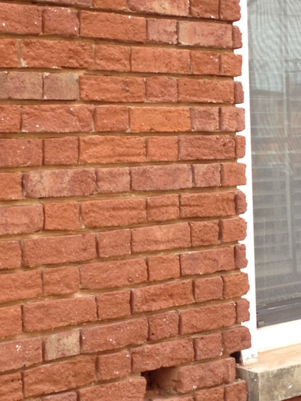 They had the blaster set to "destroy" for this job. Notice how the horizontal lines extend along the same level, from one brick to another? This was caused by the blasting material (in this case, water), the proximity of the tool to the surface (too close), and the pressure of the blasting.