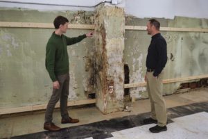 Photo of Christopher Buehler & Rich Fishburn looking at Quinby Building